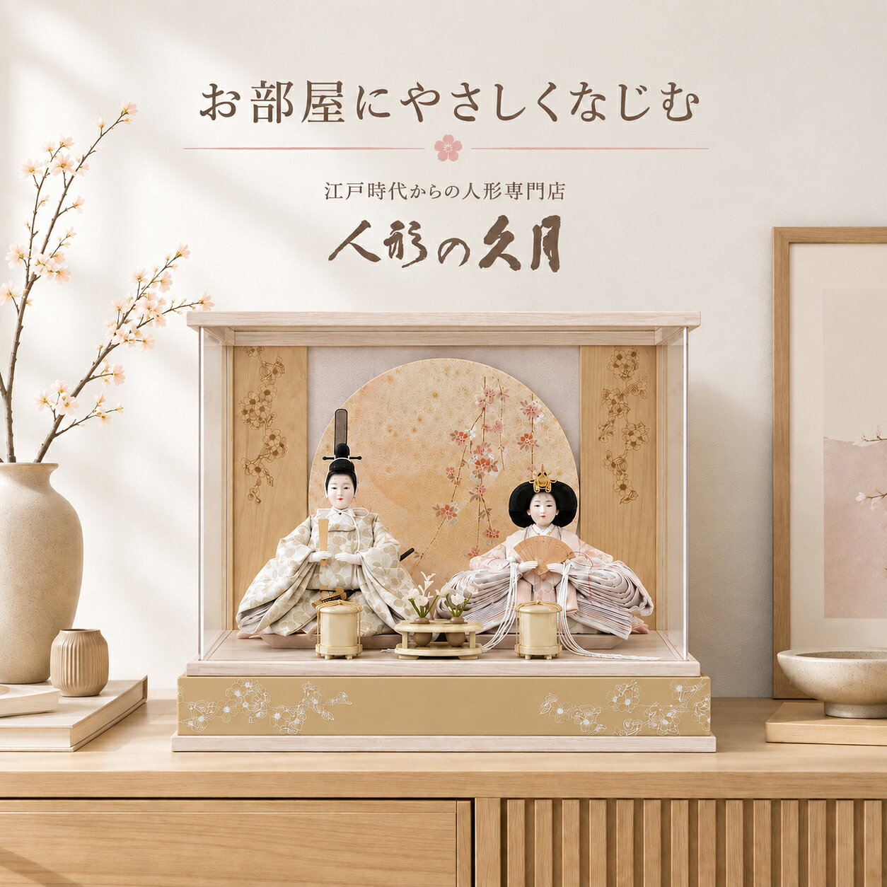 人形の久月 アクリルケース親王飾り 幅53cm × 奥行32cm × 高さ36cm ブランド 人形の久月 種類 雛人形・親王飾り・アクリルケース飾り 飾った時の外寸 幅53cm × 奥行32cm × 高さ36cm 主な特徴 桜意匠の丸屏風／屏風背面バックライト／久月木札付き／アクリルケース おすすめ用途 初節句・桃の節句・ひな祭り・お孫様への節句祝い お嬢様の健やかな成長と幸せを願う、大切な桃の節句。 人形の久月ならではの格式と、現代の暮らしに合うモダンなデザインを兼ね備えた雛人形です。人形の久月やさしい彩りのアクリルケース雛人形 節句人形の老舗「人形の久月」が手掛ける、上品な親王飾りです。 淡いアイボリーや桜色を基調とした色彩と透明感のあるアクリルケースが、 現代のインテリアに美しくなじみます。 中央には桜を描いた丸い屏風を配置。 屏風の後方からバックライトがやさしく灯り、 桜の模様を幻想的に浮かび上がらせます。 上品で穏やかなお顔 見るたびに心が和む、お殿様とお姫様の穏やかな表情。 やわらかな衣裳の色合いが、上品なお顔をさらに引き立てています。 お殿様は淡く落ち着いた色調の衣裳。 手元や太刀など細かな意匠まで美しくまとめられています。 お姫様は、幾重にも重なる優美な衣裳が魅力。 扇や冠などの細かな意匠も華やかさを添えます。 お道具までやさしい色調で統一 中央のお花や左右のお道具も、人形やケースに合わせた上品な色彩。 左下には「東京 久月」の木札が配されています。 灯りが映える桜屏風 丸い桜屏風の後ろからバックライトが灯り、 昼間とは異なる幻想的な表情をお楽しみいただけます。 飾った時の外寸 幅53cm × 奥行32cm × 高さ36cm リビング、チェスト、サイドボードなどにも合わせやすいサイズ感。 初節句・桃の節句・ひな祭りのお祝いにおすすめです。
