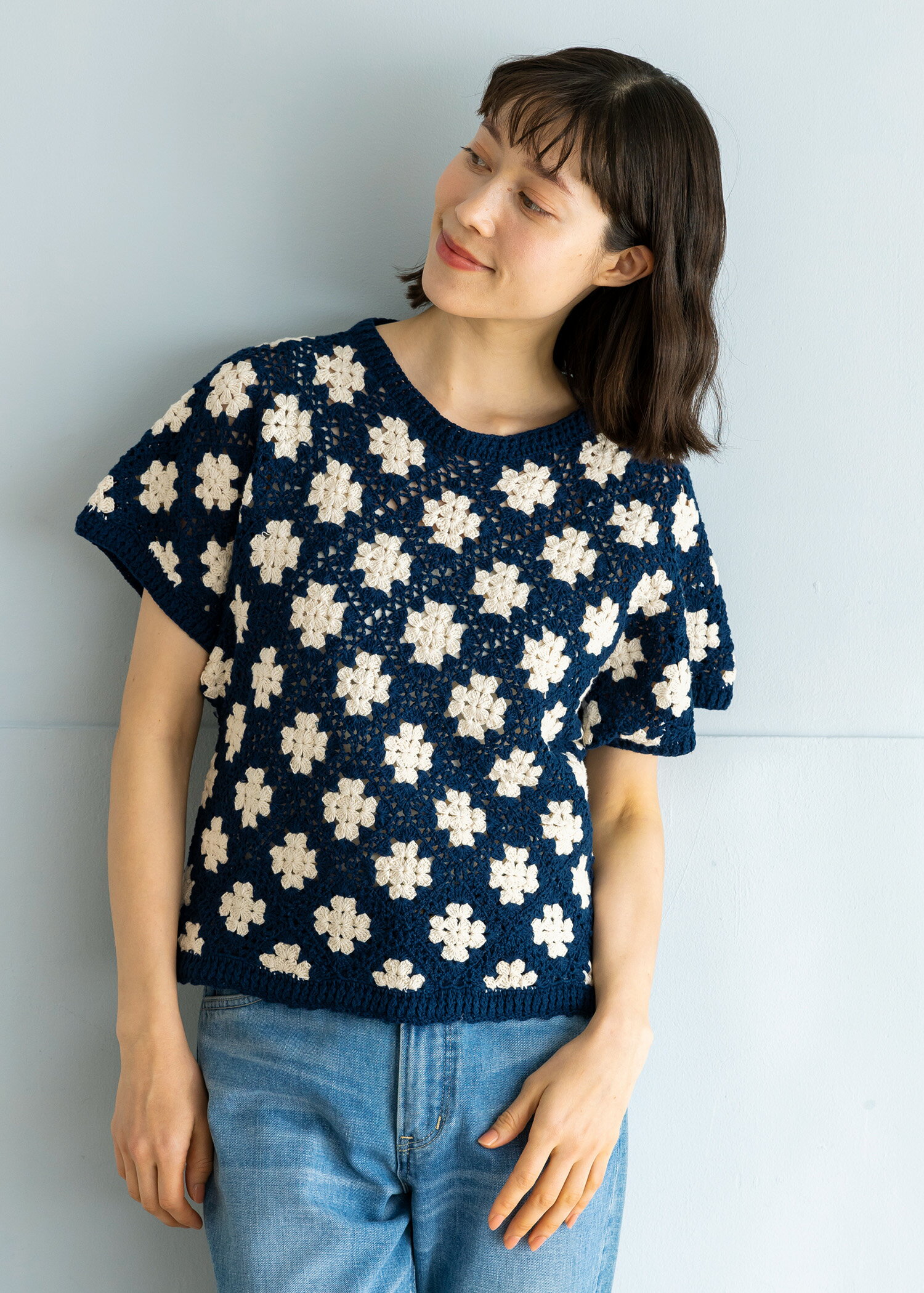 一枚でサマになる、ネイビー×白の花モチーフのインパクトある手編みのニットです。ドルマンスリーブでゆったりとした着心地で、さまざまなボトムスとも相性のいいショート丈に仕上げました。ほどよい透け感もあるので、レイヤードスタイルをお楽しみいただけます。【エシカルポイント】手編みは、自宅で家事と両立しながら収入を得られる貴重な仕事です。●コットン100%／クムベシュワール・テクニカル・スクール（KTS）／ネパールより※画像は、撮影時の光の当たり具合や、パソコン・スマートフォンの環境により、実際の色味と違って見える場合があります。M:バスト約90 ゆき丈約36 身丈約52cm※ラッピングをご希望の方は こちら よりラッピングサービス（税込566円）をご追加ください。