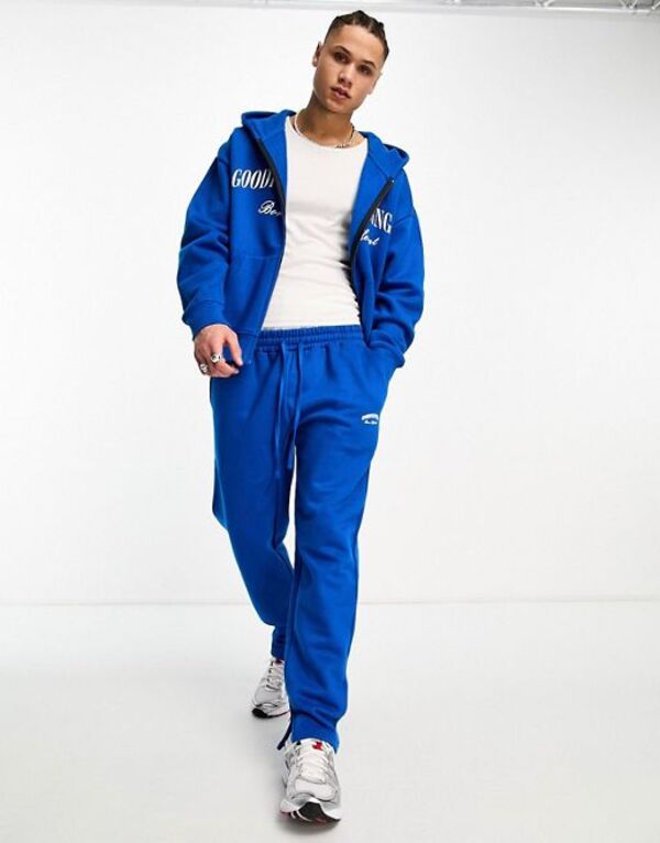 【送料無料】 グッドフォーナッシング メンズ カジュアルパンツ ボトムス Good For Nothing straight leg sweatpants in cobalt blue with logo print and hem split - part of a set Blue