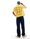 【送料無料】 エイソス メンズ Tシャツ トップス ASOS DESIGN boxy oversized t-shirt in heavyweight 220gsm washed yellow with nostalgic phone graphic Solar power