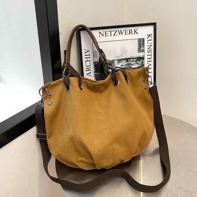 ・カラー展開: ブラック、カーキ・スタイル: 都市ミニマル・素材: キャンバス・バッグのスタイル: トートバッグ・バッグのサイズ: 中・デザイン要素: ステッチ・裏地素材: 合成皮革・バッグの形状: バケツ型・開閉方式: マグネットボタン・バッグの内部構造: ファスナーポケット・硬度: やや柔らかめ・外ポケットの種類: 内パッチポケット・ショルダーストラップ本数: 1本・対応シーン: 日常コーディネート