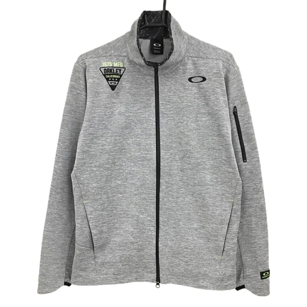 【超美品】オークリー ジャケット グレー×黒 斜めストライプ地模様 ネック内側総柄 ロゴ刺しゅう メンズ M ゴルフウェア Oakley