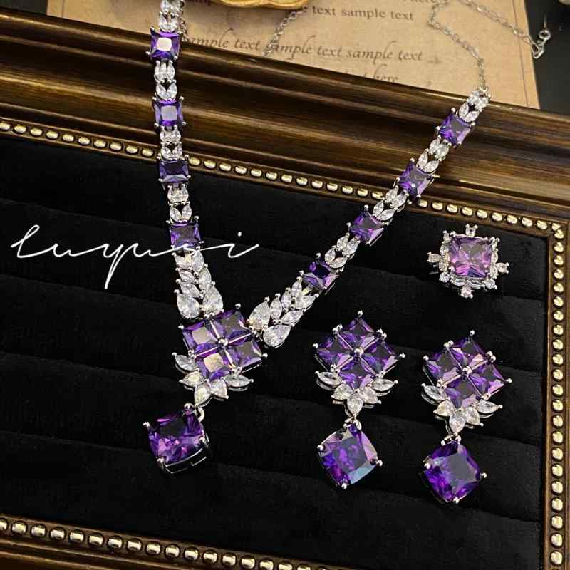 Luxury Jewelry Set for Women: A zirconia necklace in purple, colored stone earrings, and a square-cut ring. Sparkling, elegant, and sophisticated. A perfect gift for everyday wear. Stylish and glamorous.