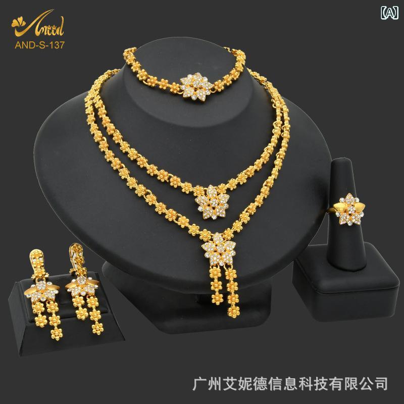 Wedding jewelry set featuring a floral motif, tapered drop design, gold-plated cubic zirconia, necklace, earrings, bracelet, and ring. Elegant and sophisticated, perfect for weddings, wedding accessories, and everyday wear. A beautiful and sparkling set, ideal for gifts.