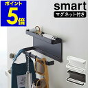 smart / スマートトレー付きマグネットアンブレラホルダー 傘や小物をまとめて玄関扉に浮かせて収納 磁石が付く玄関ドアに貼るだけで簡単に設置できる『 smart（ スマート ）トレー付きマグネットアンブレラホルダー 』。強力マグネットで固定するので、長傘や折りたたみ傘もまとめて掛けることができます。上部はトレーになっており、除菌スプレーや印鑑などの小物置きに便利。お好きな位置に取り付けられる付属のフックは、鍵やマスク、エコバッグの吊り下げ収納に。インテリアになじむモノトーンのシンプルな玄関収納です。“ヤマジツ”の愛称で親しまれる山崎実業は、「くらしを整える」商品を提案し続けています。 スペック 品番 5041 / 5042 サイズ 外寸：約 幅 200mm×奥行き 70mm×高さ 95mm トレー内寸：約 幅 195mm×奥行き 40mm×高さ 15mm 重さ 約 590g 素材 本体：スチール（ 粉体塗装 ）、マグネット 耐荷重 本体：約 2kg フック：約 250g ※衝撃をゼロとした場合の静止耐荷重です。 ※鉄の厚みや表面の塗装、壁面の強度や状態によって異なります。 取り付け可能な場所 マグネットがつく平らな面、スチール壁面 付属品 フック お手入れ ・汚れや水分が付着した際は、乾いた布で拭きしっかり乾かしてください。放置するとサビの原因となります。 ・シンナーやベンジンなどの薬品は塗装を傷めるので、使用しないでください。 ご注意点 ※製品仕様やパッケージは改良のため予告なく変更される場合があります。 ※サイズや色味は個体により若干の差異が生じることがあります。 ※スチール扉等に取り付けた際、扉の開閉は静かに行ってください。衝撃により製品や収納したものが落下する恐れがあります。 ※重心の偏りのないようバランスよく収納してください。 ※サイズや形状によっては、収納できないものもあります。 ※直射日光や火が直接当たる場所、高温になる所では使用しないでください。 山崎実業 公式 オンラインショップsmart スマート（ 山崎実業 ） トレー付きマグネットアンブレラホルダー 5041 / 5042 傘や小物をまとめて玄関扉に浮かせて収納 磁石が付く玄関ドアに貼るだけで簡単に設置できる『 smart（ スマート ）トレー付きマグネットアンブレラホルダー 』。強力マグネットで固定するので、長傘や折りたたみ傘もまとめて掛けることができます。上部はトレーになっており、除菌スプレーや印鑑などの小物置きに便利。お好きな位置に取り付けられる付属のフックは、鍵やマスク、エコバッグの吊り下げ収納に。インテリアになじむモノトーンのシンプルな玄関収納です。 Point マグネットで玄関ドアに設置 磁石の付く玄関扉に貼り付けるだけの簡単設置。スペースが限られた玄関でも場所を取らず、傘や小物を引っ掛けてコンパクトに収納できます。 小物を置けるトレー 上部には小物を置けるトレー付き。除菌スプレーや印鑑など、玄関でよく使うアイテムをまとめておけます。 取り外しできるフック付き お好みの位置に取り付けられるフックが付属。鍵やマスクなどを掛けておけば、すぐ手に取れるので、お出かけの準備もスムーズに。 傘以外の小物収納にも 長傘や折りたたみ傘はもちろん、エコバッグやサングラスなどを掛けても◎。ホルダー部分は片側が開いているので、サッと横から掛けられます。 size color 山崎実業「smart」シリーズの商品一覧はこちら