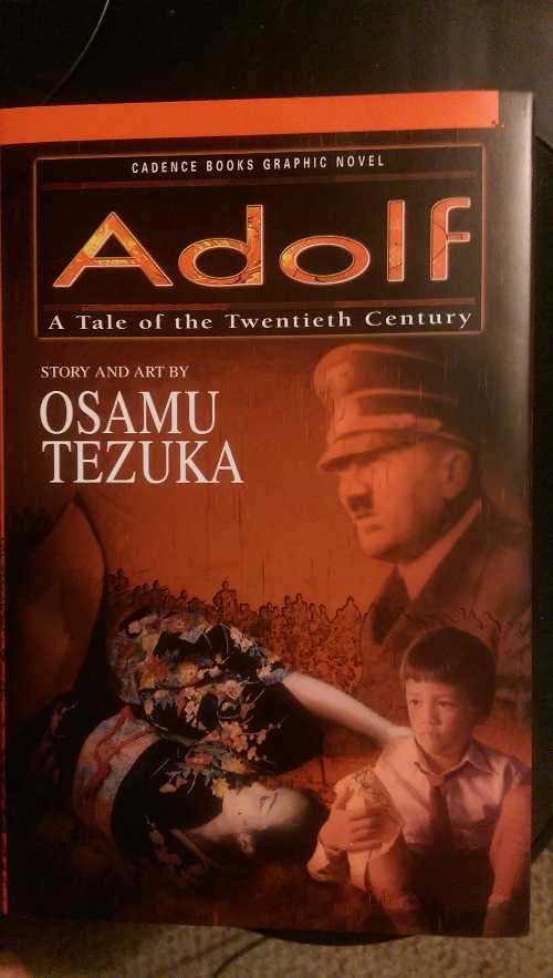  Adolf: A Tale of the Twentieth Century (Cadence Books Graphic Novel) - Osamu Tezuka; Osamu Tezuka; Annette Roman; Frederik L. Schodt; Yoshiyuki Higuchi; Yuji Oniki (Cadence Books)  9781569310519