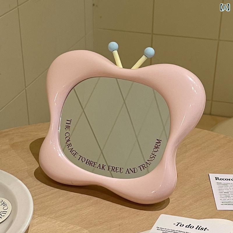 手鏡 コンパクト バタフライ メイクアップミラー スタンド アップ テーブル ホーム ドレッシング テーブルは 手持ち 式 ポータブル 寮 デスク トップ ポータブル高 解像度 ミラーを 掛ける ことが できます