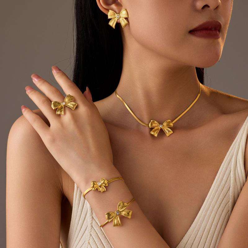 Ladies' Jewelry Set: Stainless Steel, Electroplated, Zirconia, Ribbon Motif Necklace, Earrings, and Ring. High-Quality Fashionable Set for Everyday Wear, Office, Casual, and as a Gift for Birthdays and Anniversaries.