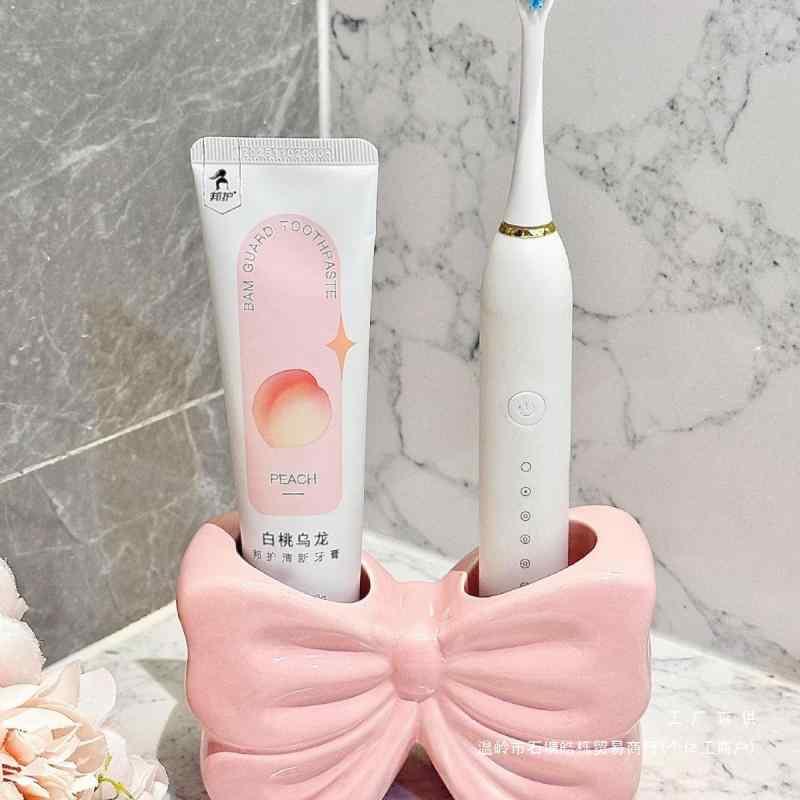 歯ブラシスタンド レディース 歯ブラシホルダー 歯磨き粉ホルダー 洗面台 収納 吸盤式 かわいい リボン