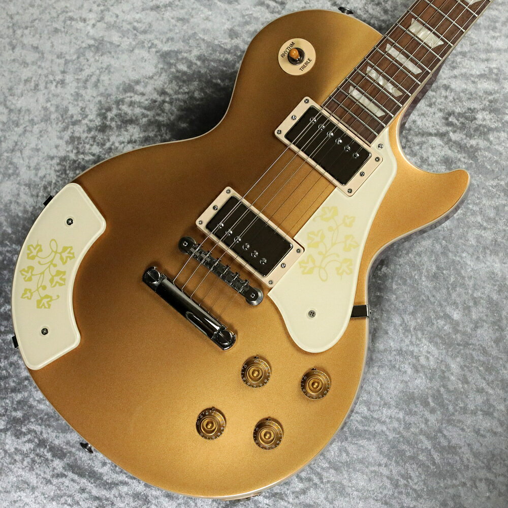 レスポール・ギターの生みの親レス・ポール氏の妻にして人気ミュージシャンであったメアリー・フォードのシグネチャー・モデル『Mary Ford Les Paul Standard』【特徴】今回入荷した「Mary Ford Les Paul Standard」は1958年にメアリー・フォードのリクエストにより制作された、レスポール・ゴールドトップ・モデルを再現したモデルです。このフローラル・ピックガードとアームレストを装着したレスポールゴールドトップはギブソンの記録上、1本製作されたとされています。ゴールドトップに珍しいチェリーバックを組み合わせたカラーリング、花柄アームレスト＆ピックガードなど唯一無二のルックスを実現。メイプルキャップを持つマホガニーボディにスリムテーパーネック、Burstbucker 2＆3ピックアップを搭載し、多彩なサウンドを奏でます。20世紀を代表する革新的アーティストを称える逸品で、ハードシェルケース付きの特別モデルです。【商品のコンディション】新品・展示品・メーカー保証付属・現品画像掲載【担当者コメント】花柄のピックガードとアームレストが特徴的なレスポールスタンダードゴールドトップ。当時Gibsonにて本人のリクエストで一本作られたとされています。このモデル以外にもギターを抱えたメアリーの写真は残されていますので、プレーヤーとしても優秀な方だったのでしょう。（担当：勝部）この商品についての詳しいお問い合わせは TEL：0570-020-025 または「お問い合わせフォーム」よりお願いします。【】1924年7月7日生まれのメアリー・フォードは、優れたギタリスト、ヴォーカリスト、女優であり、1950年代初頭に活躍したレコーディング・アーティストの一人でした。キャリアの初期にはカントリー・ミュージック界で成功をおさめ、その後ジーン・オートリーやエディ・ディーンとのつながりを通して、ギブソンのアイコンであるレス・ポール氏と出会い共演、1949年に結婚します。このレス・ポールとメアリー・フォードのデュオは1951年だけで600万枚以上のレコードを売り上げ、1950年から1954年にかけて、16曲ものトップ10ヒットを記録しました。このヒット曲でメアリーは、マルチトラック・レコーディングとオーバーダビング（当時としては画期的なレコーディング技法）を駆使し、その豊かで滑らかな歌声の完璧なハーモニーと、カントリー、ジャズ、ポップスをシームレスに融合させた多彩なギター・プレイを披露しました。【詳細情報】【ボディ】- ボディシェイプ：Les Paul- ボディスタイル：Les Paul- ボディ材：Mahogany- トップ材：Maple- バインディング：Single-ply (Top, Fretboard)- フィニッシュ：Gloss Nitrocellulose Lacquer- ウェイトリリーフ：なし【ネック】- ネック材：Mahogany- ネックシェイプ：SlimTaper- スケール長：628.65 mm / 24.75 in- 指板材：Indian Rosewood- 指板R：304.8 mm / 12 in- フレット数：22- フレット：Medium Jumbo- ナット材：Graph Tech- ナット幅：43.05 mm / 1.7 in- 指板エンド幅：57.4 mm / 2.26 in- インレイ：Acrylic Trapezoid- ジョイント：Glued In, Set Neck【エレクトロニクス】- ネックピックアップ：Burstbucker 2- ブリッジピックアップ：Burstbucker 3- コントロール：2 Volume, 2 Tone (Hand-wired with Orange Drop Capacitors)- ピックアップセレクター：3-way Toggle- 出力ジャック：1/4【ハードウェア】- ブリッジ：ABR-1 Tune-O-Matic- テイルピース：Aluminum Stop Bar- ペグ：Vintage Deluxe with Keystone Button- ペグプレーティング：Nickel- ピックアップカバー：Nickel- コントロールノブ：Gold Top Hat with Dial Pointer- スイッチチップ：Amber- スイッチワッシャー：Cream- ピックガード：ES-295 Style, Cream with Gold Floral Design- マウンティングリング：Cream- ジャックプレートカバー：Cream- ストラップボタン：2- トラスロッド：Adjustable- トラスロッドカバー：Black 2-ply (Blank)- ハードウェアフィニッシュ：Nickel【その他】- モデル：LPSMF00GCNH1- ケース：Hardshell- 付属品：Gibson Accessory Kit- ヘッドストックインレイ：Mother of Pearl Gibson Logo, Gold Silkscreen Les Paul Model- 弦ゲージ：.010, .013, .017, .026, .036, .046■重量：4.35kg■製造年（代）：2024■シリアルNo：234440030■ハードケース付属 【ご注意】 ●メーカー保証付き。メーカー保証期間終了後も島村楽器全店で通常よりもお安く修理、調整いたします。●商品の詳細、状態などはオンラインストア 0570-020-025 または商品画像下の「お問い合わせ」ボタンよりお問い合せください。●商品は専任スタッフ及び専属リペアマンの調整・弦交換含めたクリーニング・最終チェックをした上で出荷させていただきます。●こちらの商品はイオンモール幕張新都心店店頭でも同時に販売しております。　●店頭売却時の商品情報の削除は迅速を心掛けておりますが、万一ご注文後に売り切れとなっておりました場合は誠に申し訳ございませんがご容赦ください。●商品によって、調整等でお届けにお時間をいただく場合がございます。予めご了承ください。 ■管理コード:0209000791356