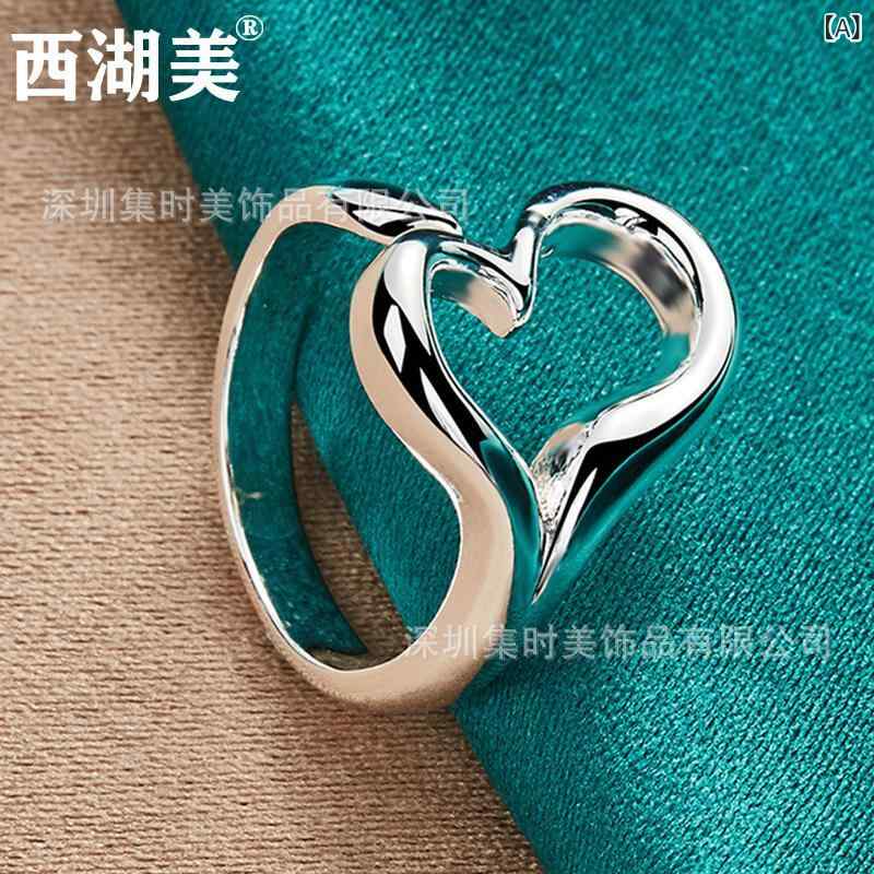 西湖の 美しい 銀は 透かし 彫りの 愛の 指輪を 飾って 口を 開けます。