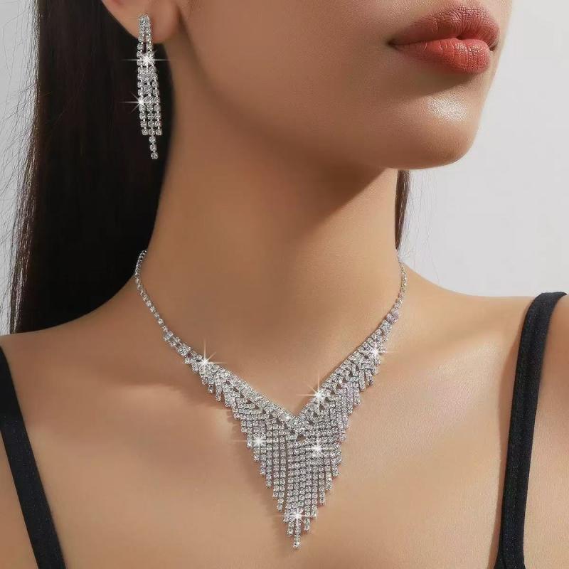 Necklace and Earrings Set for Women: A gorgeous, sparkling rhinestone necklace and earring set featuring a V-shaped fringe. Perfect for bridal occasions, weddings, receptions, and formal events. Silver finish.
