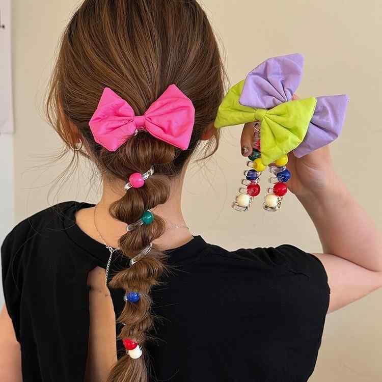 ・カテゴリ: 電話線ヘアゴム・素材: 布・処理プロセス: 完全り・カラー展開: ピンク（大きなリボンとカラービーズ）、パープル（大きなリボンとカラービーズ）、グリーン（大きなリボンとカラービーズ）・スタイル: カートゥーン、清新で甘いスタイル・デザイン: 高弾力