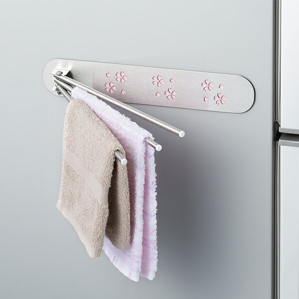 ピンクの桜模様がキレイなふきん掛け 冷蔵庫横などにマグネットでピタッと取り付け、空間を有効活用できる 使わないときは邪魔にならないように、たたんでスリムになる サイズ(約):横30×縦5.5×奥行2cm (折りたたみ時) 本体重量(約):225g 素材・材質:本体/ステンレススチール、パイプ部/18-8ステンレス、キャップ部/ABS(アクリロニトリル・ブタジエン・スチレン)樹脂、取付具/シートマグネット 生産国:日本