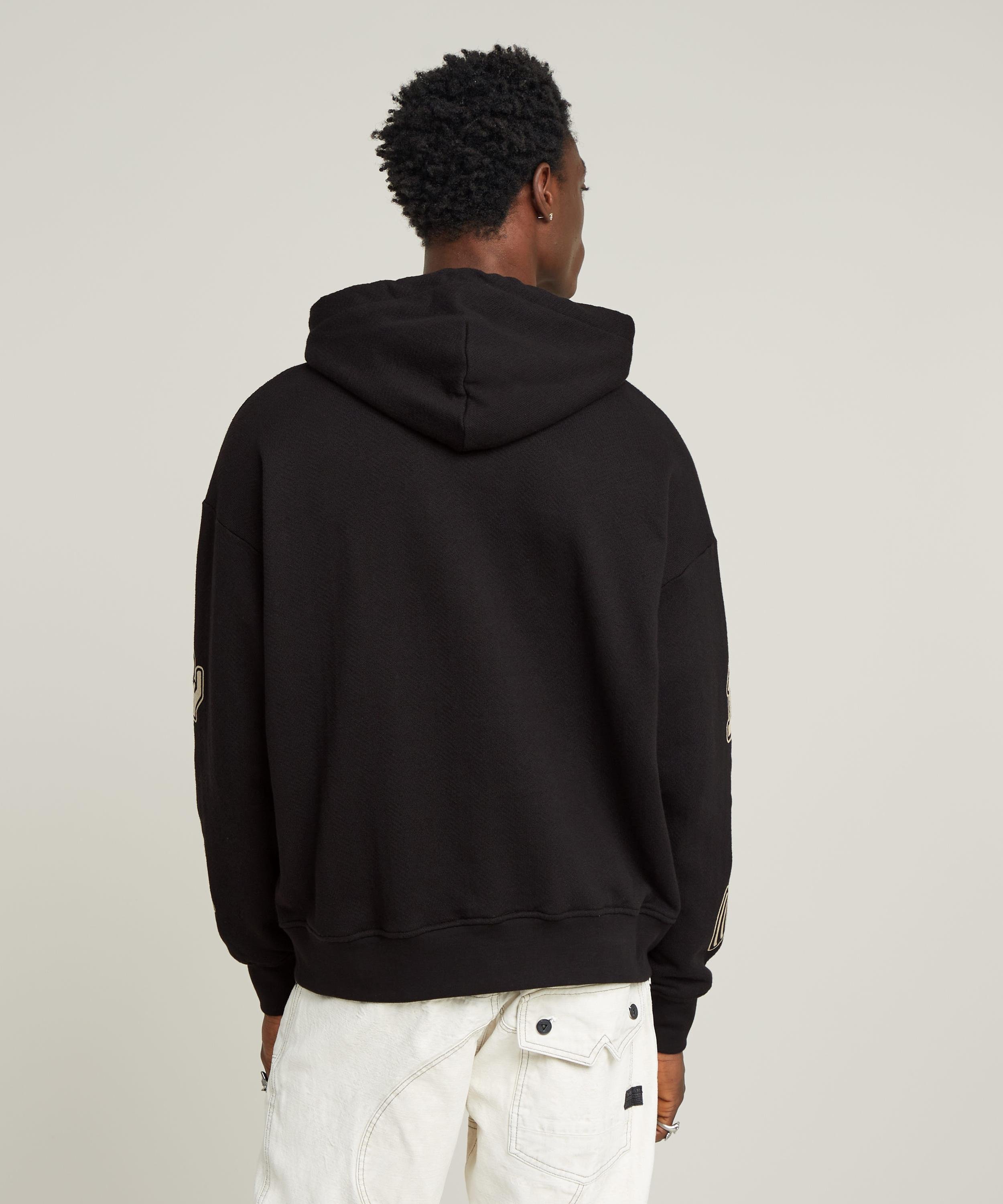 【公式ショップ】MULTI LOGO LOOSE HOODED SWEATER/マルチグラフィックブランドロゴオーバーサイズパーカー ジースターロゥ トップス パーカー・フーディー ブラック