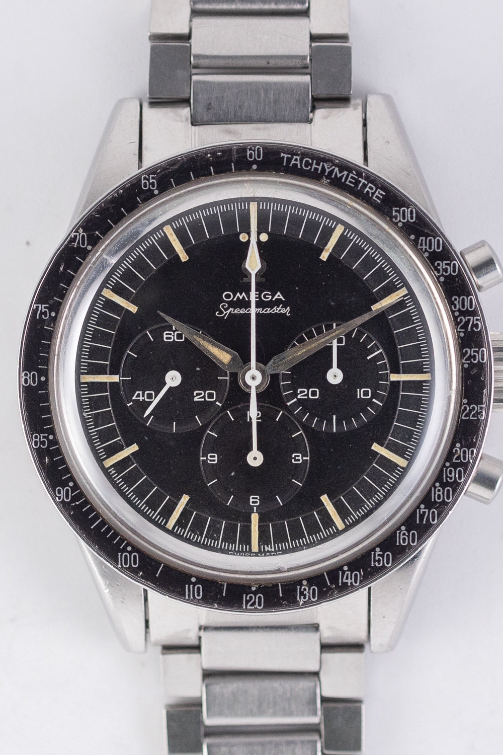 ? COMMENT オメガのレジェンド、スピードマスターRef.2998。リューズガードが無く、ストレートラグが際立つ無骨なケースデザインが特徴です。4mmプッシュボタンが絶妙なバランスで、初期スピードマスターの存在感を高めています。ヴィンテージスピードマスターならではのシルバーカラーのアルファハンドが、このモデルに一層の趣を添えています。日本ではキャタピラーと呼ばれるフラットリンクブレスレットは、Ref.7912、エンドリンク6、クラスプデイト63/2とともに装備されています。搭載ムーブメントはCal.321で、ピラーホイール式を採用しているため製造コストが高く、チラネジテンプと巻き上げヒゲを備えた高級仕様です。 ベゼルには写真で確認できる通り、程よい使用傷とカラーフェードがヴィンテージらしい雰囲気を醸し出しています。ケースは大きな打痕などなく、プロポーションが非常に良好です。ダイヤルは理想的な状態です。ほぼ無傷で、良い状態を維持しています。夜光塗料は経年により一部変色し、さらに独特のヴィンテージ感を引き立てています。付属のキャタピラーブレスレットはエラスティックファンクションが正常に機能しています。弊社にて分解掃除済みで、すべてが正常に作動します。 このスピードマスターは、NASAが月に持ち込んだモデルよりもさらに前の世代にあたります。ブレスレットまでオリジナルを揃えるのは非常に困難であり、2998の枝番によってデザインが細かく異なる中、オリジナリティを保った非常に貴重な一本です。 BRAND 今でこそ「Speedmasterイコール宇宙」という図式がすぐに浮かび上がりますが、当時は宇宙とは全く関係のない、純粋なモータースポーツ用の時計として誕生。また、スピードマスターは、ダイヤルではなく外周ベゼルにタキメーターを表示した世界で初めての時計と言われています。1959年、スピードマスターはマイナーチェンジをします。ベゼルがアルミニウムの黒色ベースとなり、針の形状がアロー針からアルファ針に変更されたことで、より視認性が高まっています。NASAは宇宙での過酷な環境にも耐えうる丈夫なクロノグラフを探しており、名だたる強豪に勝ったスピードマスターを公式時計として採用。その後1969年人類初の月面着陸の際、スピードマスターを着用していたことは有名な話。 ? ?BRAND OMEGA MODEL Speedmaster REFERENCE 2998-61 YEAR 1962 MATERIAL Stainless Steel WINDING Manual CALIBER 321 SERIAL 195++++ CASE DIAMETER? 39.0mm CASE THICKNESS 13.4mm BETEWEEN LUGS 19.0mm SERVICE Yes GUARANTEE 1 Year STRAP OMEGA Genuine Bracelet BOX and PAPERS No ? COMMENT The Omega Speedmaster Ref. 2998 is a true legend in the world of horology. Known for its rugged case design with straight lugs and the absence of crown guards, this model embodies the essence of early Speedmasters. The 4mm pushers are perfectly balanced, enhancing the overall presence of this iconic timepiece. The silver-colored Alpha hands, a hallmark of vintage Speedmasters, further add to its charm. It comes equipped with the flat-link bracelet, known as the "Caterpillar" in Japan, featuring Ref. 7912, end links numbered 6, and a clasp dated 63/2. Inside, the watch is powered by the revered Caliber 321, a column-wheel movement with high-end features such as a screw balance and Breguet overcoil, reflecting the higher manufacturing costs of the time. As seen in the photos, the bezel exhibits signs of wear and slight color fading, which enhances the watch’s vintage appeal. The case remains in excellent shape with no significant dings or scratches, preserving its proportions beautifully. The dial is in near-perfect condition, showing minimal signs of aging. The luminous material on the hands and indices has developed a patina over time, further accentuating the unique vintage aesthetic. The attached "Caterpillar" bracelet retains its elastic function and operates smoothly. The watch has been fully serviced by our team and functions flawlessly. This Speedmaster belongs to a generation even prior to the models taken to the Moon by NASA. Assembling an original set, including the bracelet, is quite challenging, and given the subtle design differences among the 2998's sub-references, this piece is remarkably valuable for preserving its originality. BRAND Today, the association of the Speedmaster with space is instantly recognisable, but it was originally conceived purely as a motorsport watch, entirely unrelated to space. Moreover, the Speedmaster is said to be the world's first watch to display the tachymeter on the outer bezel rather than the dial. In 1959, the Speedmaster underwent a minor change: the bezel transitioned to a black aluminium base, and the hands changed from arrow to alpha shape, improving visibility. NASA was seeking a robust chronograph capable of withstanding the harsh conditions of space, and the Speedmaster was selected as the official watch after outperforming formidable competitors. It is famously known that the Speedmaster was worn during humanity's first landing on the Moon in 1969.