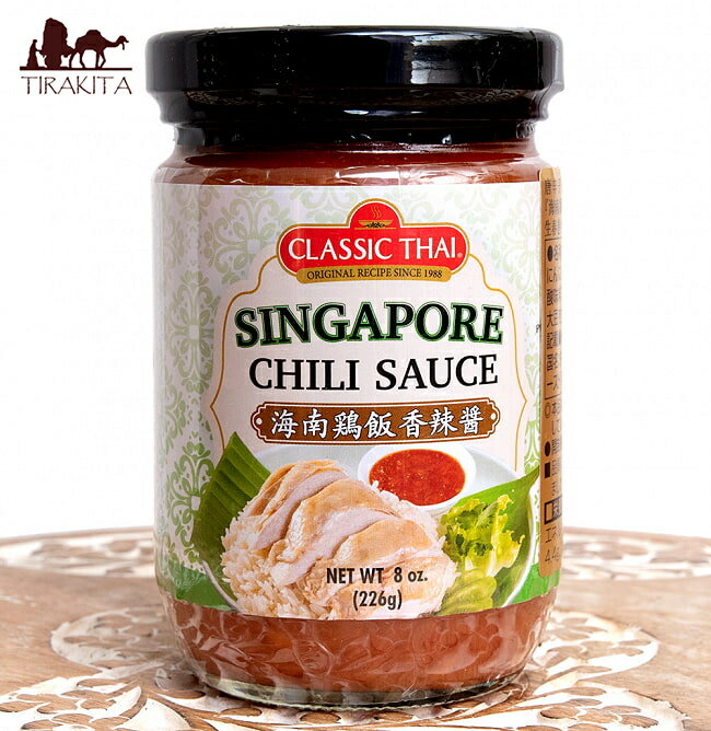 ■海南チキンライスのタレ - シンガポールチリソース - 海南鶏飯香辣醤 - SINGAPORE CHILLI SAUSE【CLASSIC THAI】の詳細 ブランドCLASSIC THAI(クラッシックタイ)原材料・成分赤唐辛子、砂糖、にんにく、しょうが、食用ごま油、醤油/酸味料、増粘剤(キサンタンガム）、 （一部に小麦・ごま・大豆を含む）名称唐辛子ソース商品の内容量226グラム温度帯指定常温: 開封前は室温での保管が可能ですハラルイスラムの方でも安心のハラル食品です。容器の種類瓶製造国タイおことわり直射日光を避け保存してください。開封後は、?1)庫に保管してお早めにお召がり下さい。食品の状態ペースト商品サイズ約11cm x 6cm x 6cm 約430g賞味期限2025年08月09日かそれ以降の商品をお届けします配送についてあす楽についてクーポンプレゼントキャンペーンについてこちらの商品は「商品レビューで200円OFFクーポン プレゼント」キャンペーンの対象商品です。以下の画像をクリックで、キャンペーンの詳細ページをチェック！美味しい漬けダレ、シンガポールチリソースです。蒸しどり、カオマンガイ、海南チキンライスはもちろん、炒めものや唐揚げサラダにとアイデア次第で使い方は幾通りです。現地の調味料を使えば、現地の味を忠実に再現出来ますよ?。あたりまえかぁ・・・手に持ってみました。野菜の和え物等にも使えます。是非、お試しください。 ■海南チキンライスのつけダレ 生姜とにんにく、酸味を加えたクラッシュタイプのキレのあるチリソースです。 海南鶏飯、カオマンガイの蒸し鶏のつけダレや生春巻きや春雨サラダ（ヤムウーセン）などのソースとしてお勧めです。 また 炒め物などに加えると生姜の香りとチリソースの辛味が食欲をそそります。 ■使い方 海南鶏飯、カオマンガイの蒸し鶏のつけダレに。生春巻きや春雨サラダ（ヤムウーセン）などのソースとして。炒め物の隠し味などに