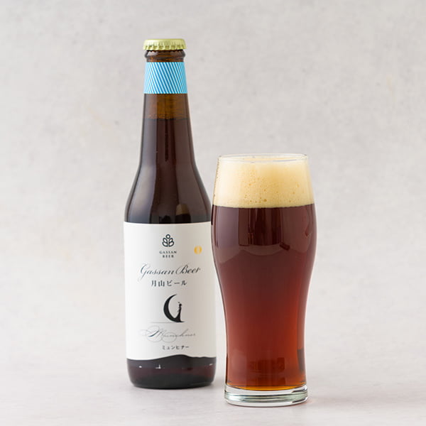 名称 ビール 内容量 月山ビール（ミュンヒナー）330ml×6本セット　 アルコール度数 5％ 原材料 麦芽（ドイツ製造）、ホップ 生産者 西川町総合開発株式会社（山形県西川町） のし 対応不可 お届け時期 1週間前後でのお届け お届け方法 　 ご注意 ●こちらの商品は2箱につき1件の送料が発生いたします。そのため、2箱以上ご注文の場合は複数回ご注文をお願いいたします。●普通のビールに比べ賞味期限が短かめとなっておりますのでご注意ください。 ●箱、ラベルのデザインは画像と異なる場合がございます。 ●納品書、請求書などは同封しておりません。 ●他の商品と同梱はできません。 ●ギフト対応でご注文される方は、受け取られる方へ予めご連絡しておく事をお勧めいたします。長期不在等で商品の傷みが増したり、受け取ることが出来なかった場合、責任をお受けいたしかねますので、予めご了承ください。西川町総合開発／月山ビール ミュンヒナー330ml×6本セット[箱入] 月山の湧水×本場ドイツの醸造技術。山形生まれの本格クラフトビール 月山ビールは、本場ドイツの醸造技術によって作られる本格クラフトビールです。ドイツのビール純粋令に基づき、原料は麦芽、ホップ、水のみです。麦芽100%の、副原料なしのため、麦芽由来の穀物の甘み、うまみがしっかり感じられます。 また、麦芽、ホップ、酵母はビールの本場ドイツやチェコ産のものを使用し、世界が認めるカスパー・シュルツ社の醸造機器と、ドイツの醸造技術をもって正直に作られています。 また、ビール造りに大切な水については、日本有数の豪雪地帯として知られる月山に降り積もった雪が融け、数百年ともいわれる長い長い年月をかけて研かれた湧水を使っています。 こだわりの原材料と本場ドイツの技術をもちいて作られる本格クラフトビールです。 ホップの苦みを抑え、麦芽の香り・うまみをゆっくりと堪能できるミュンヒナー 月山ビールにはミュンヒナーとピルスナーがございます。こちらの商品はミュンヒナー×6本セットでお届けします。 ［ミュンヒナー］ ローストモルトを使用した濃色のビール。 ホップの苦みを抑え、麦芽の香り・うまみをゆっくりと堪能できます。黒ビールほどくせがなく、それでいて芳醇な香とコクが味わえます。黒ビール好きにはもちろんですが、普段黒ビールはあまり飲まないという方にもおすすめしたいビールです。 西川町総合開発とは 西川総合開発は、山形県のちょうど真ん中辺りに位置する「西川町」にあります。西川町は出羽三山で知られる月山（がっさん）がある町としても知られ、豊かな自然と綺麗な水に恵まれた環境です。 同社が運営する「道の駅にしかわ」には、山形県唯一の地ビール醸造工場があり、本場ドイツの醸造技術で作られる本格クラフトビール（月山ビール）を味わうことができます。 こだわりが詰まった月山ビール。ミュンヒナーの味わいをどうぞお楽しみください。 ●こちらの商品は2箱につき1件の送料が発生いたします。そのため、2箱以上ご注文の場合は複数回ご注文をお願いいたします。