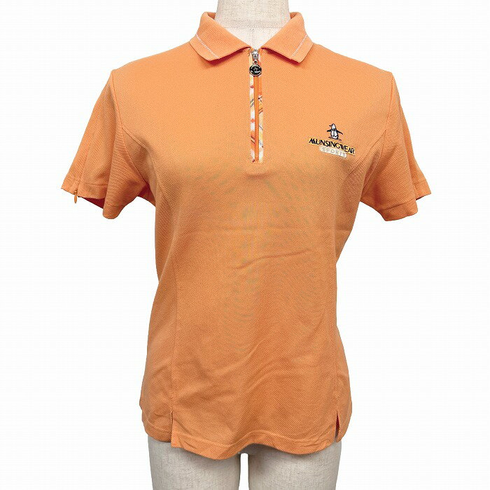 Polo Shirt - 【中古】Munsingwear Grand Slam マンシングウェア グランドスラム ポロシャツ 日本製 ハーフジップ ゴルフ 袖口ジップ 裾の両面にスリット 一部チェック ペンギン 半袖 綿×ポリ M オレンジ レディース
