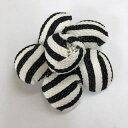 ベラコサージュです。織の粗いしっかりとしている生地で作っています。一枚花弁を丸く模って、組み合わせています。裏側はピン付です。