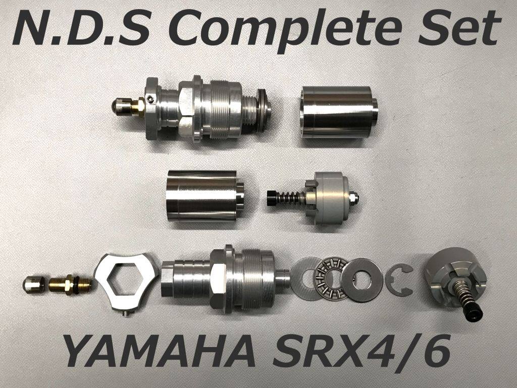 ■商品概要フォーク径：Φ36 スタンダードスプリング用ライダーの体重に合わせた選択が可能ですセット内容・BURRITO(ブリィート)・イニシャルアジャスター・ベアリング・センタリングカラー■詳細説明■BURRITO＋イニシャルアジャスター＝ネコアシダンパーシステム(NDS)コンプリートセットセットフロントフォーク全体のバランスを整え、妥協のない理想の走りを実現するセッティングパーツのセットです。■開発の背景と目的・低コスト車の課題：廉価モデルや旧車に多い「フローティングバルブ式」フォークは、コストが低い反面、きめ細かな減衰特性の調整が困難でした。・開発の狙い：高価な「カートリッジ式」フォークのような、幅広い速度域に対応する優れた減衰特性を、低コストなフォークでも実現するために開発されました。■BURRITO(ブリィート)の特徴・進化した減衰コントロール：従来の類似品とは異なり、圧側(縮み)だけでなく、走りの要となる「伸び側」の減衰特性も大きく見直しています。・セッティング可能：シムとバルブの厚みを変更することで、伸び側ダンピングの調整が可能です。こんなライダーにお試し頂きたい部品です。・現在のフロントフォークの減衰特性に不満がある方・社外品のバネに変えて、減衰不足を感じている方・リアサスだけを高性能品に変えたことで、前後のバランスが崩れてしまった方■注意点※カラーのない車両への取り付けは基本的にできません。(例外車種はあります。)※フォークオイルの量はオイル量ではなく、必ず油面高さで管理してください。(BURRITOの体積は約20cm3になりますが、フォーク径によって製品体積が若干変わります。)※製品中央のボルトを締め込むことで圧側減衰力が上がりますが締め込みは必ず初期位置から1回転半までとしてください。(過度に締め込むとオイルロックを起こしフォーク作動中にいきなり動かなくなる場合があり大変危険です。)※画像には他のタイプが含まれている場合があります。※メーカー都合により商品の仕様変更がある場合がございます。ご了承ください。■適合車種SRX-4&ensp;SRX-4SRX-6&ensp;SRX-6