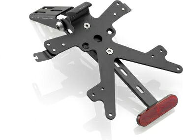クリックするとRizomaページで製品をご覧いただけます。部品番号です。PT704B ・ブラックアルマイト? 欧州規格に準拠? E-Homologated LED SMD License Light? 簡単かつ迅速に取り付けられるように設計? 軽量で機能的? 各キットにはUSAサイズのプレートホルダーが含まれています。当社のライセンスプレートサポートキットには、ライセンスプレートサポート、ライセンスプレートサポートライト、ウインカーライトサポート、リフレクターキットが含まれています。